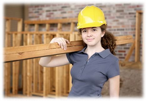 Woman wearing a hard hat holding plywood