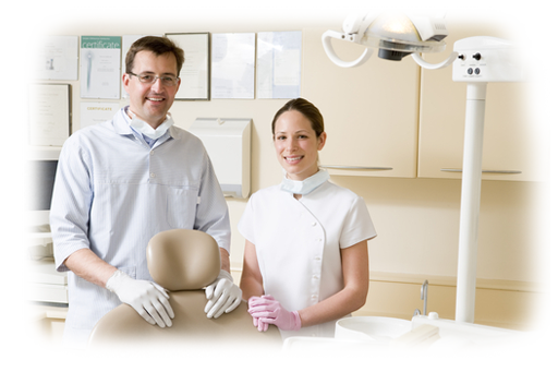 Dentist and hygienist standing by chair