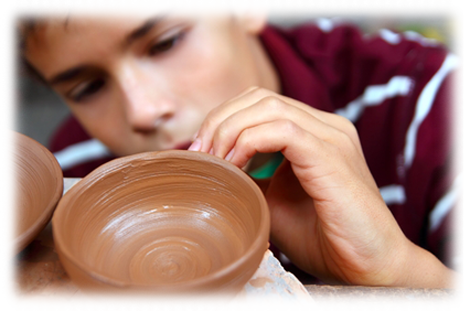 Person making pottery on a wheel